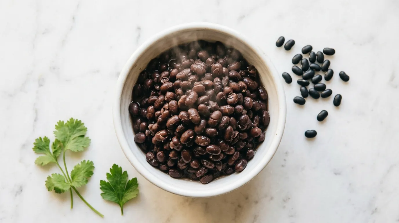 Bowl of black beans on white marble — beans and legumes reduce blood sugar A1C in diabetics