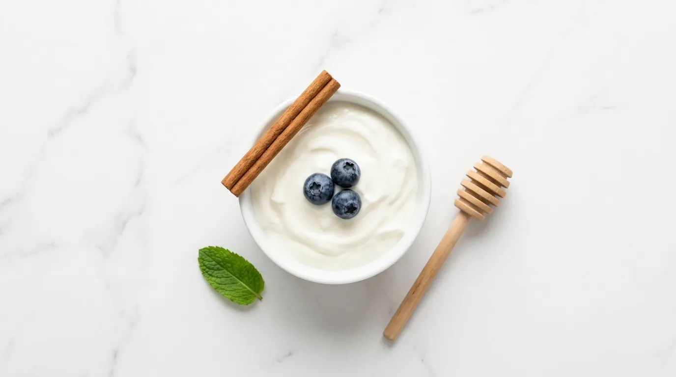 Bowl of plain Greek yogurt with blueberries and cinnamon on white marble — Greek yogurt fermented dairy blood sugar benefit diabetics
