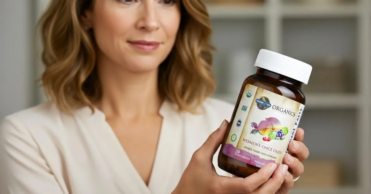 Woman holding Garden of Life Women’s Once Daily Multivitamin — whole food multivitamin for energy, hair, skin, nails, and overall women’s health