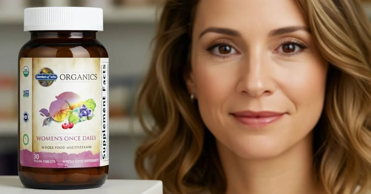 Adult woman smiling in a clean, bright setting, with the Garden of Life Women’s Once Daily Multi bottle positioned beside her.
