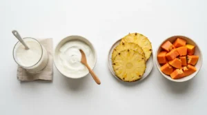 probiotics vs digestive enzymes comparison showing kefir yogurt pineapple and papaya