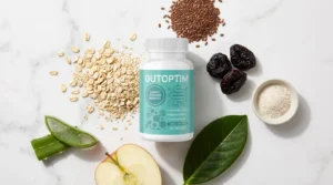 GutOptim bottle beside oats aloe vera flaxseed prunes psyllium and apple on white marble — GutOptim ingredients full breakdown what research actually shows 2026