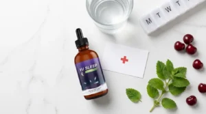 Yu Sleep bottle beside safety cross card water glass tart cherries and lemon balm on white marble — Yu Sleep side effects safety risks and medication interactions honest guide 2026